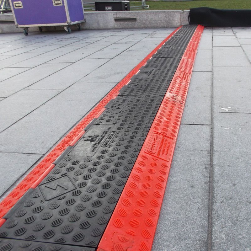 Cable Ramp Black Line 5-Channel low-profile application example on pavement (Article No. 2011132)