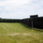 Gewebeplane schwarz - blickdichter Sichtschutz Schwarze Gewebeplane als Sichtschutz an langer Bauzaunreihe auf einer Wiese