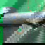 Kabelbinder schwarz - witterungsbeständiges Befestigungsmaterial  Nahaufnahme von zwei scharzen Kabelbinder, die eine geöste Ecke eines dubkelgrünen Mesh Banners am Bauzaun fixieren